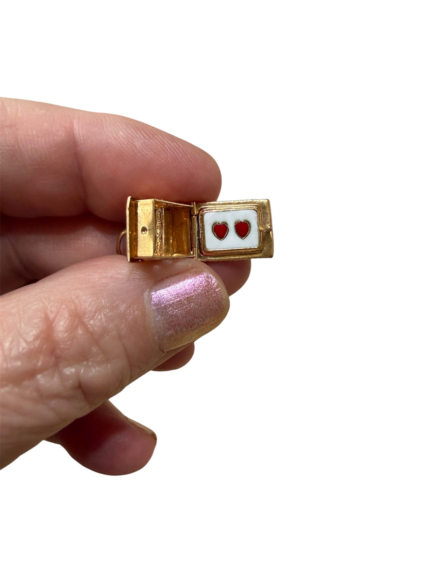 18ct vintage swiss chalet charm with two hearts inside.