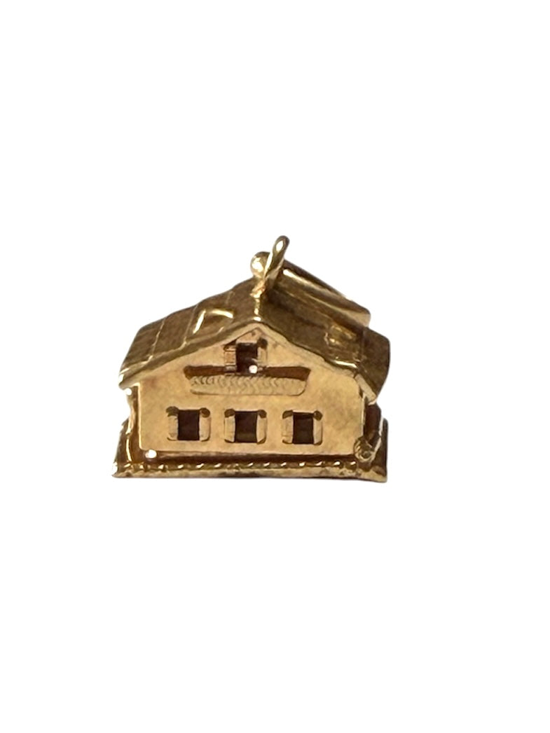 18ct vintage swiss chalet charm with two hearts inside.