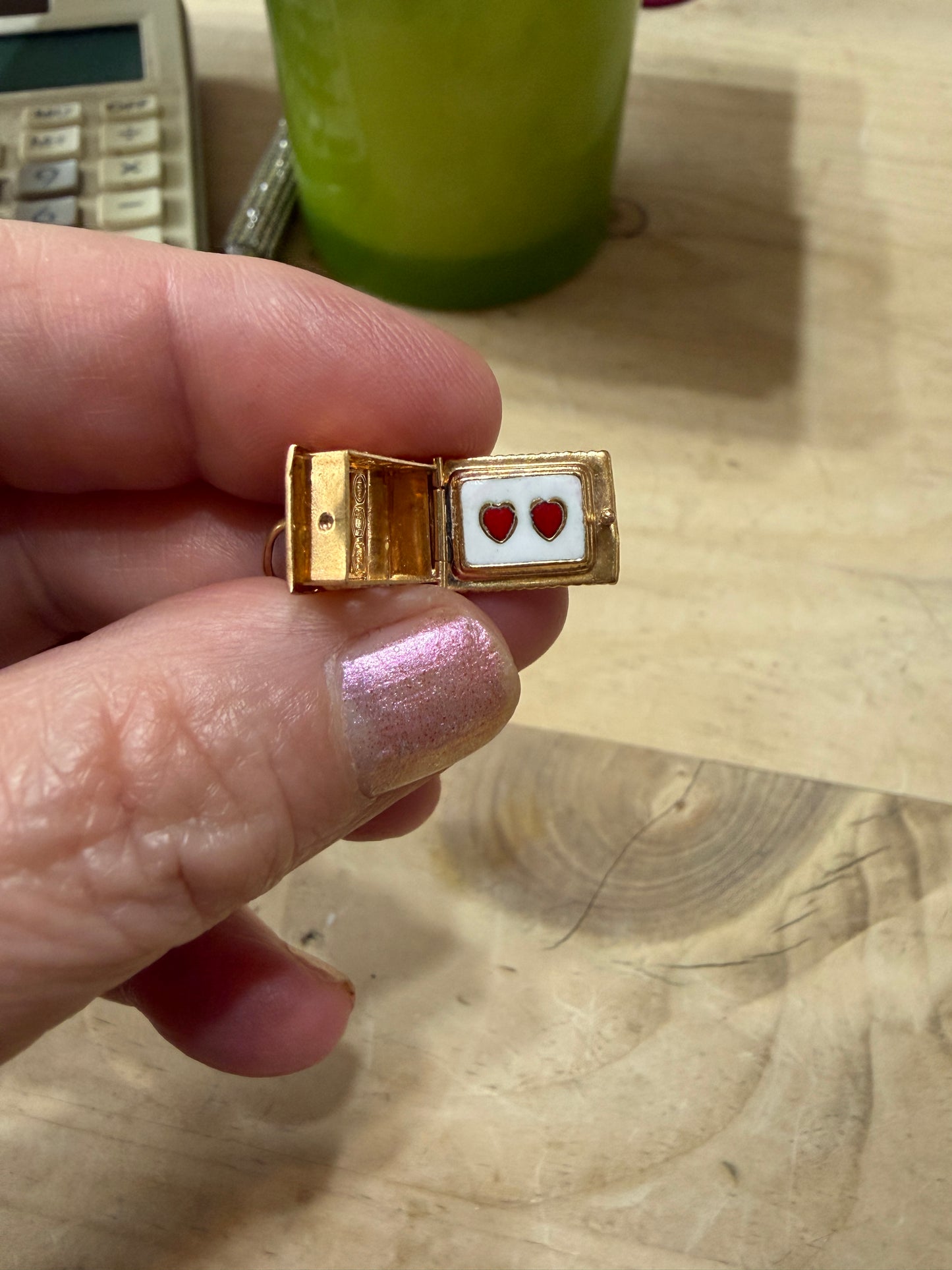 18ct vintage swiss chalet charm with two hearts inside.