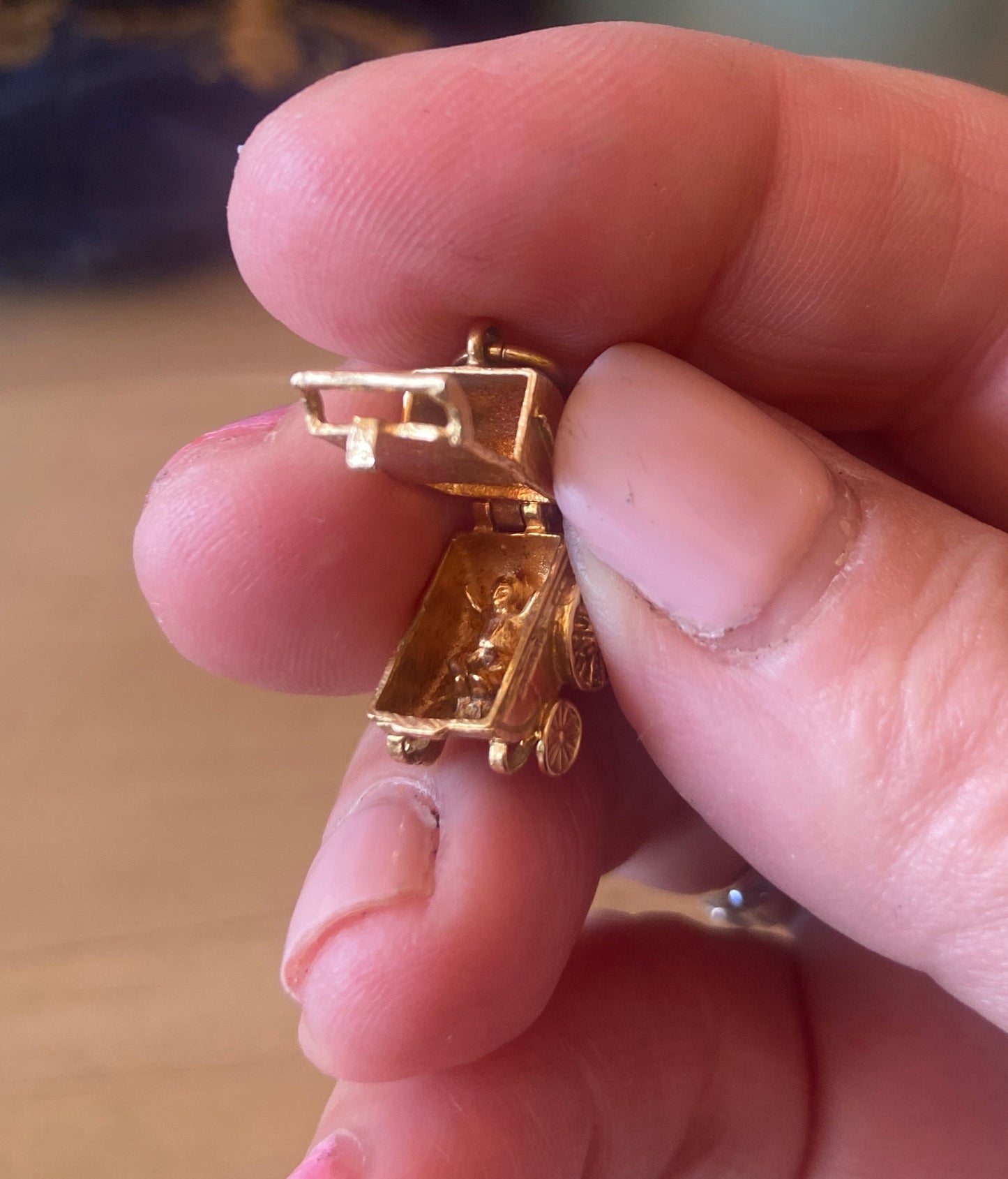 9ct vintage opening pram charm with baby inside.
