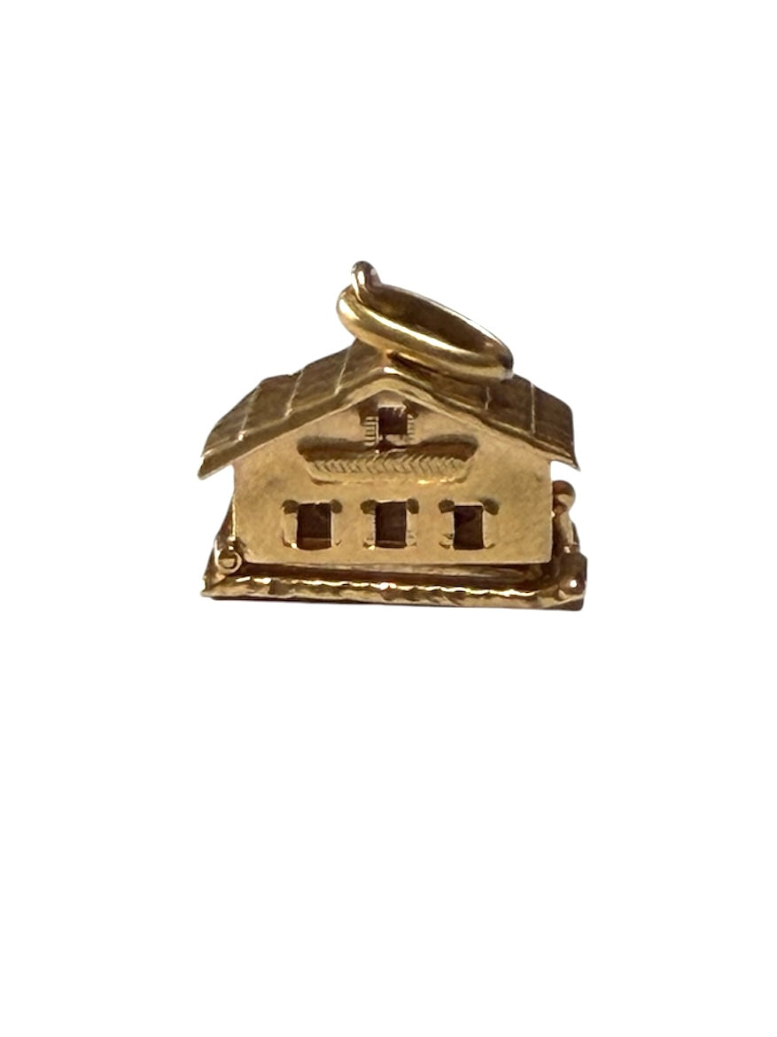 18ct vintage swiss chalet charm with two hearts inside.