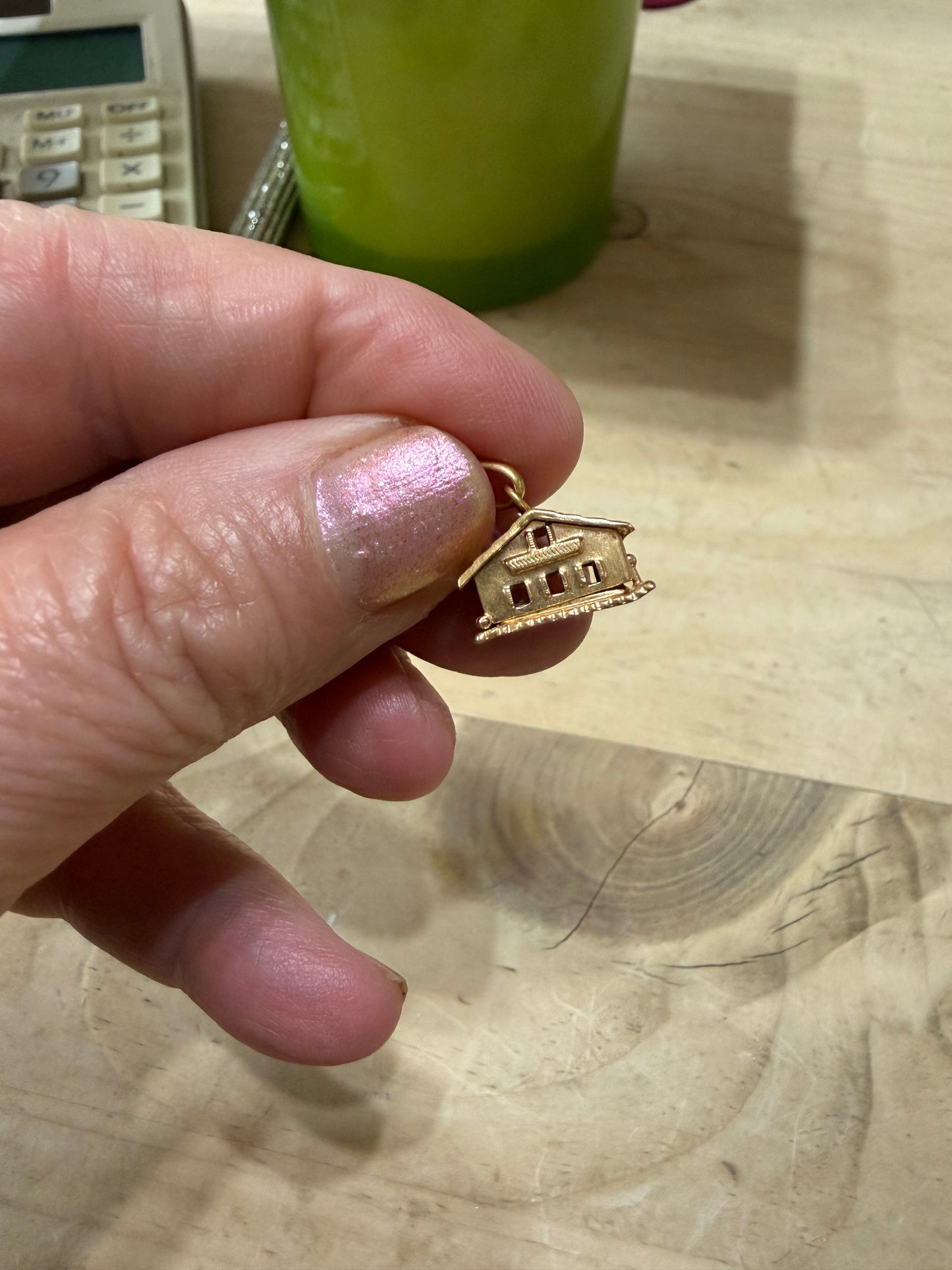 18ct vintage swiss chalet charm with two hearts inside.