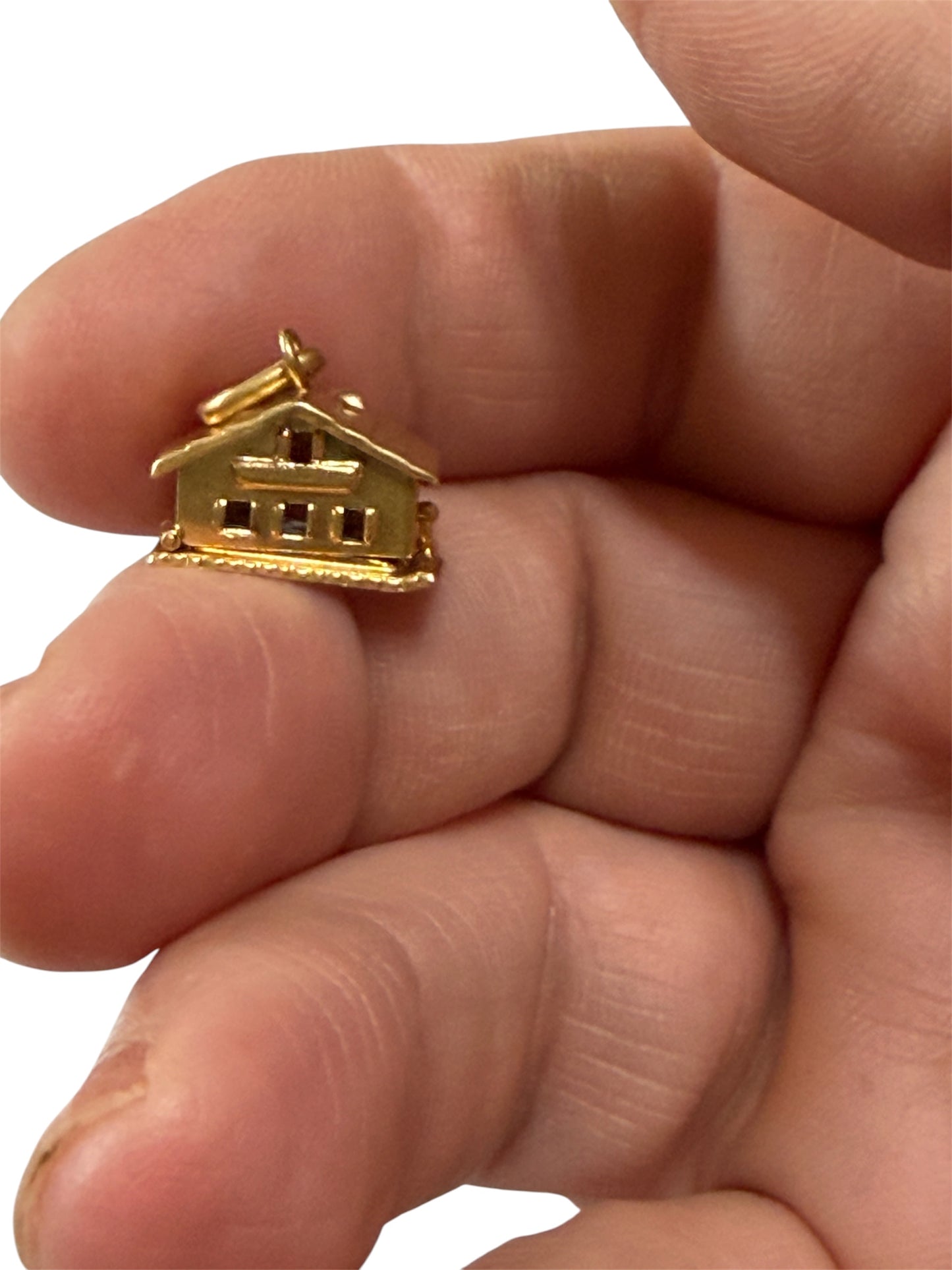 18ct vintage swiss chalet charm with two hearts inside.